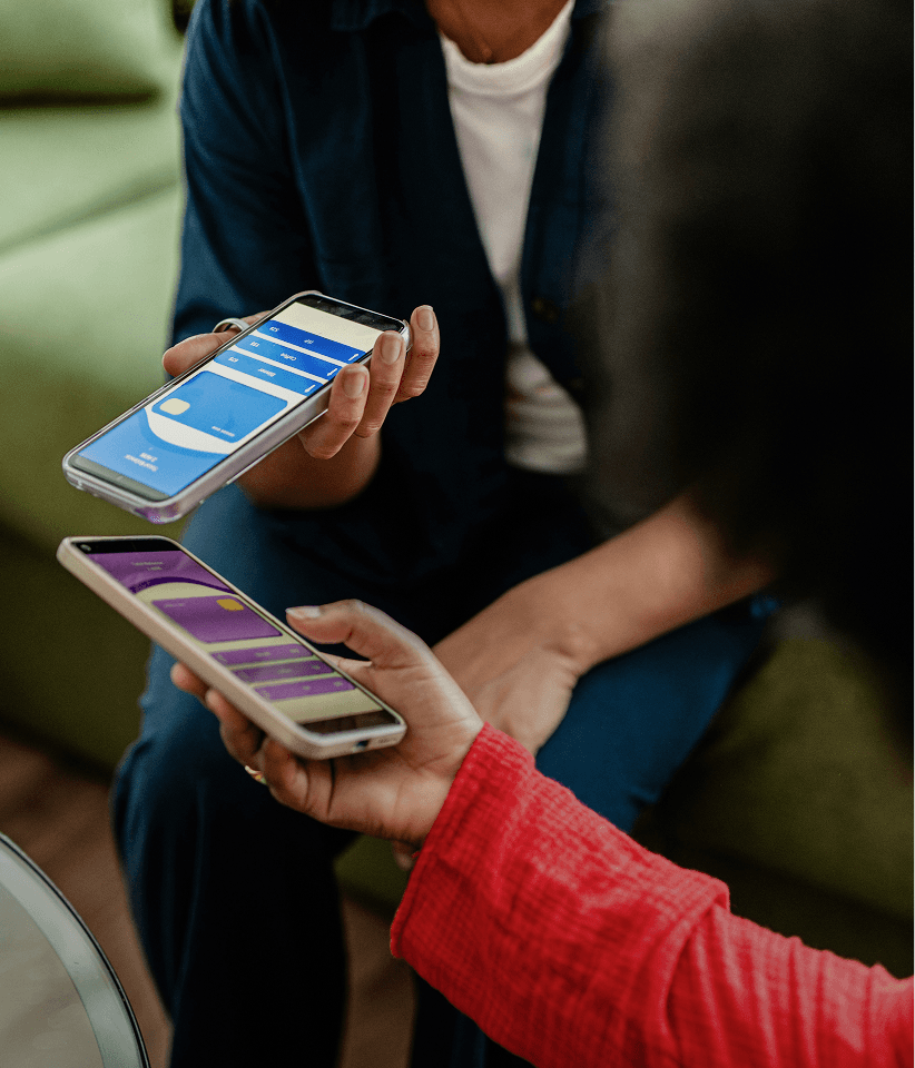 Two individuals are holding smartphones displaying message delivery statistics, focusing on SMS deliverability.