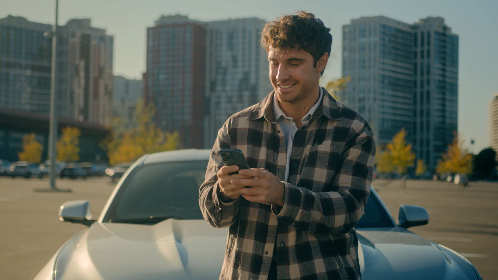 Smiling man Caucasian businessman blogger texting messages mobile phone addicted internet social media chatting smartphone outdoors happy joyful male guy tourist driver travel car automobile in city. High quality 4k footage