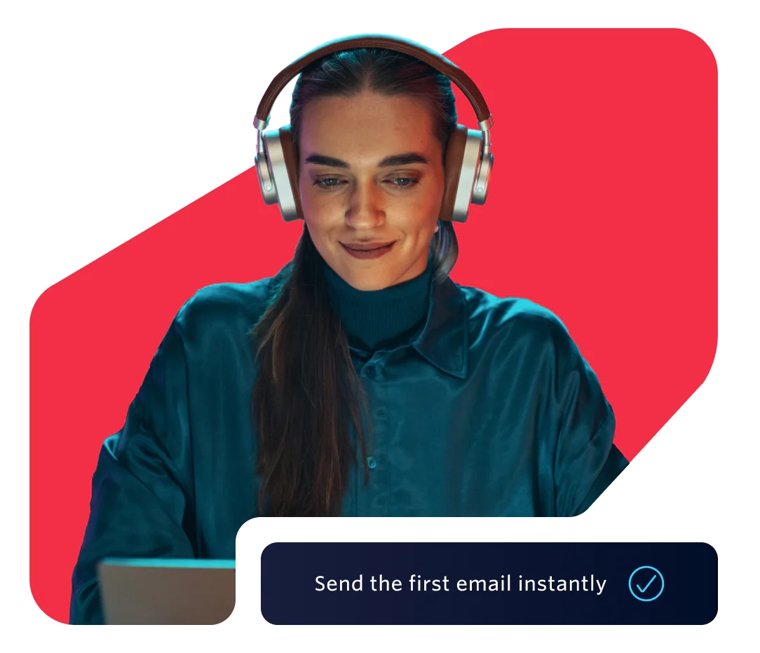 Woman in headphones using a laptop with a prompt to send the first email instantly