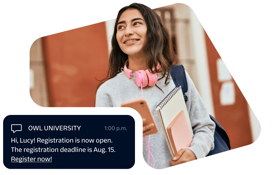 Smiling student with pink headphones, holding books and phone, receiving registration message from university.